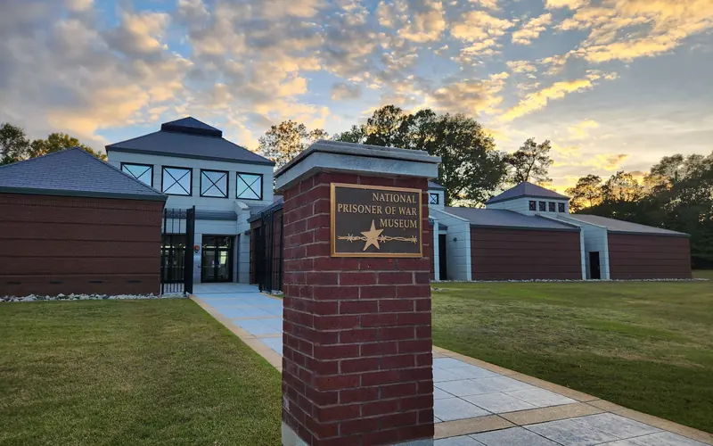 Large brick museum with a sign in front reading "The National Prisoner of War Museum"