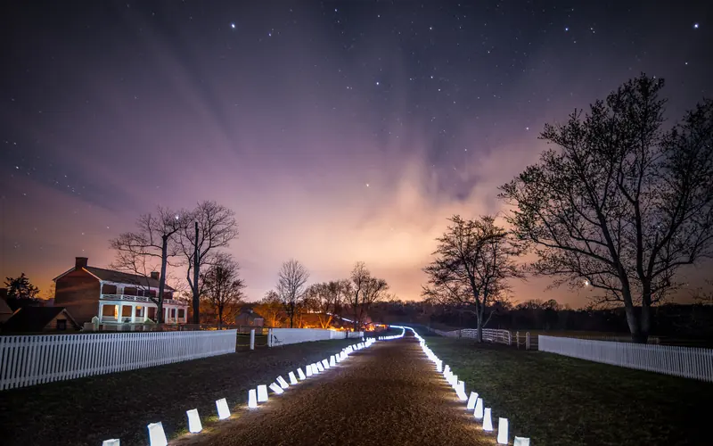 The McLean House during the 150th Anniversary with luminaries along the Stage Road.