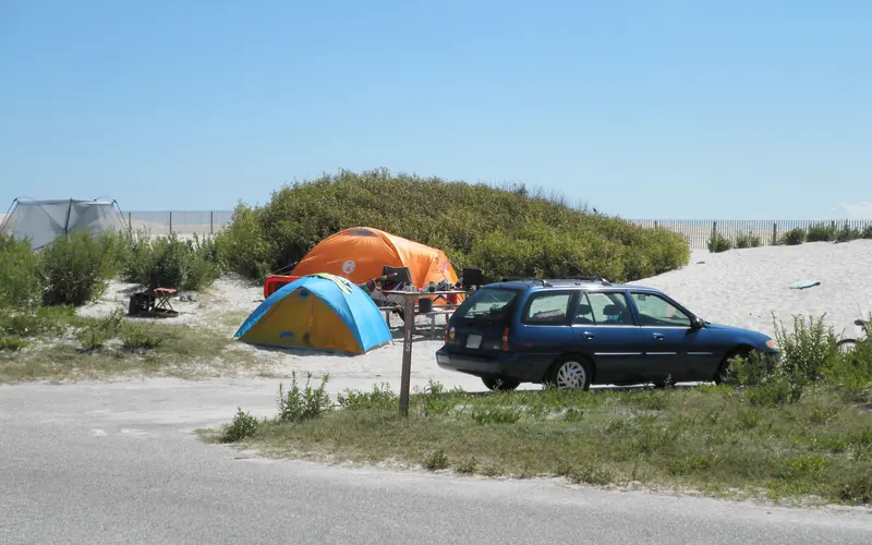 tents and vehicle in the oceanside campground dunes