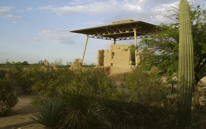 earthern Great House with its roof among desert plants