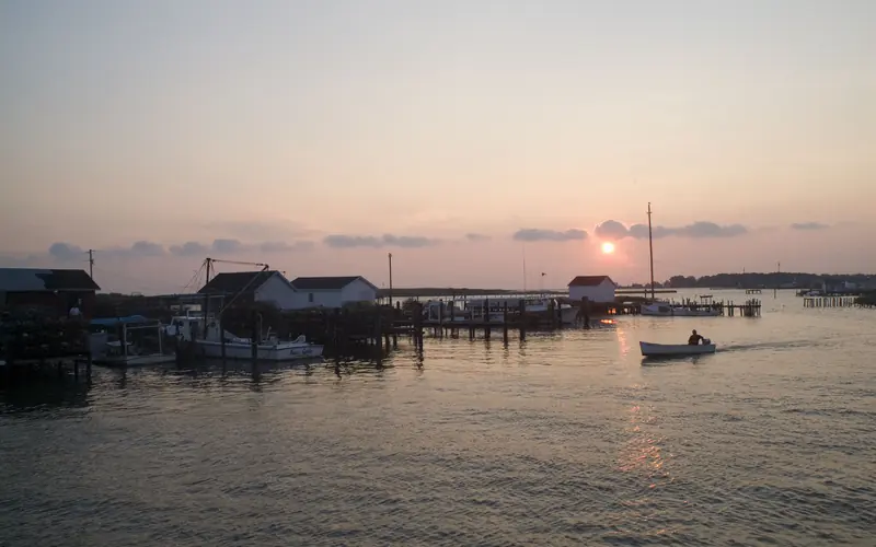 At sunset, a boater returns to the docks used by working watermen at Tangier Island.