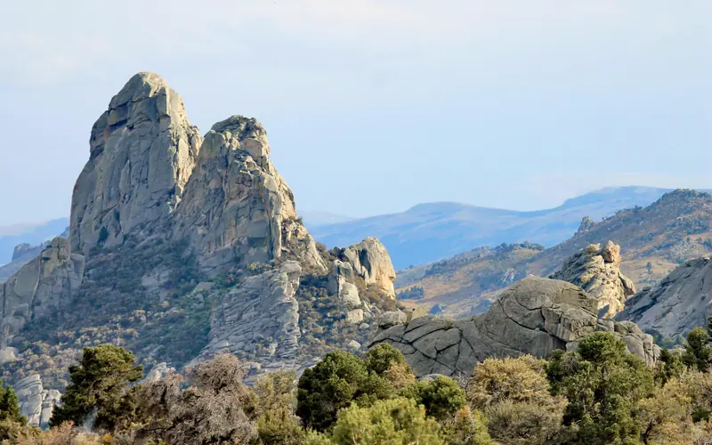Two granite pinnacles right next to each other that are similar in size and shape.