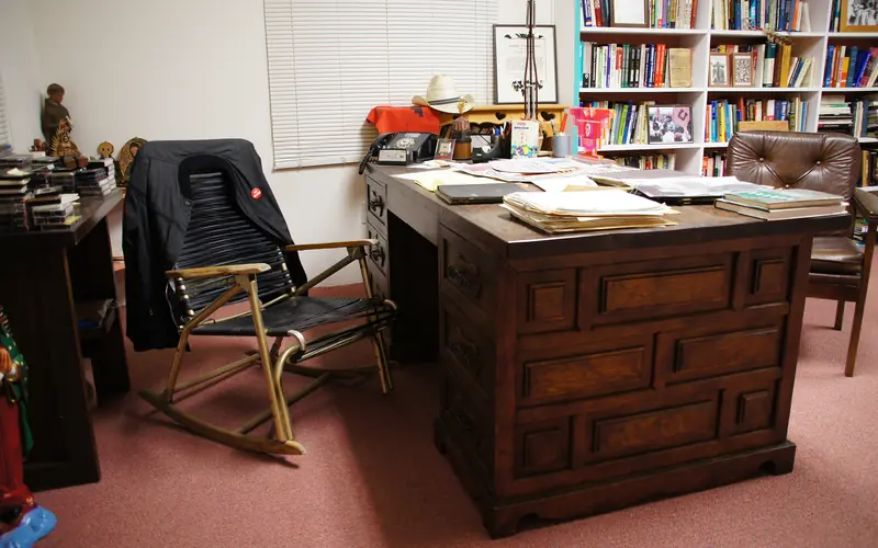 A chair and desk near bookshelves