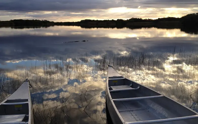Two canoes at Nine Mile Pond during sunset.
