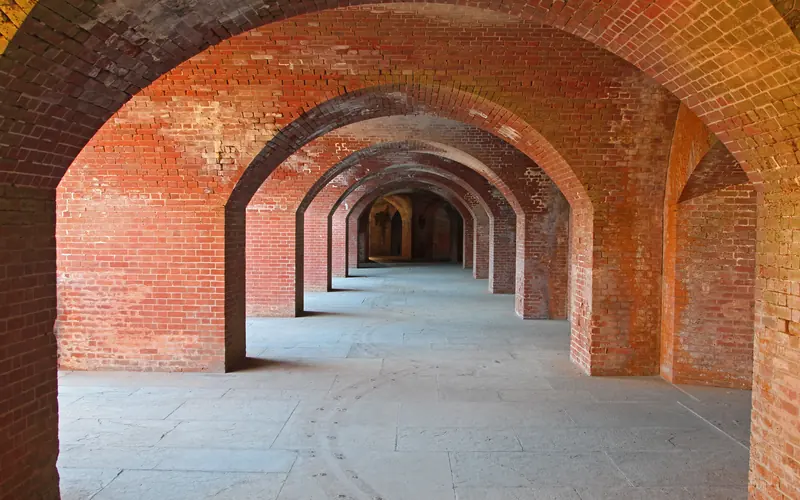 Arched red brick casemates extend into the distance at Fort Point.