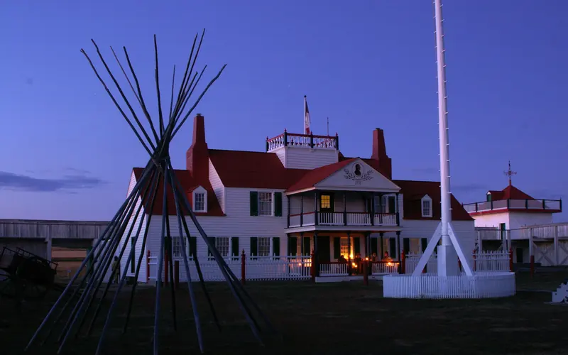 Candles illuminate the Bourgeois House porch at dusk