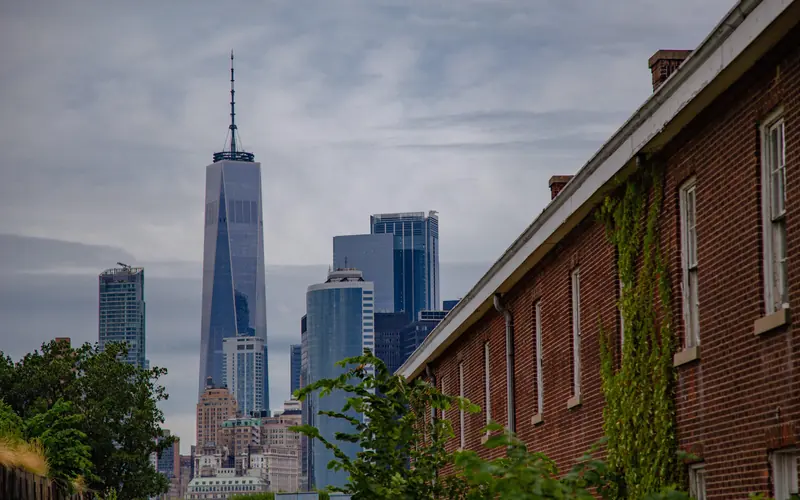 Manhattan Skyline stands behind the barracks of Fort Jay