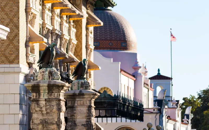 Stone entrance pillars in front of a row of four bathouses