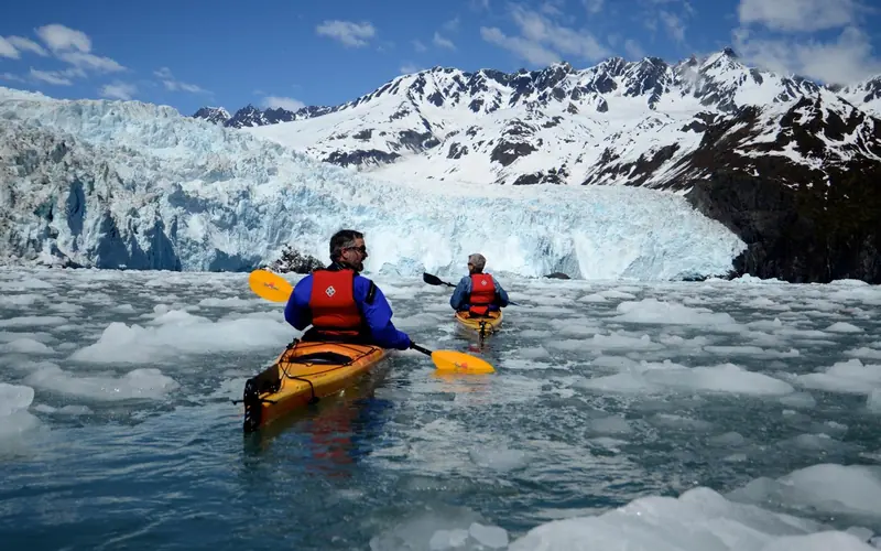 kayakers in front of a tidewater glacier