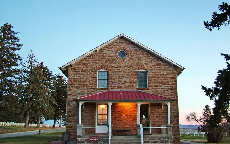 The stone house sits on the edge of the Custer National Cemetery.