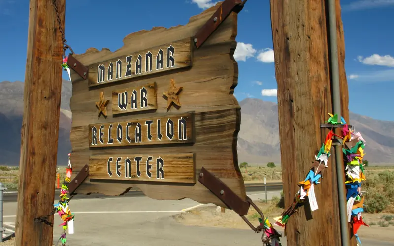 Wooden sign with "Mananar War Relocation Center" written on it