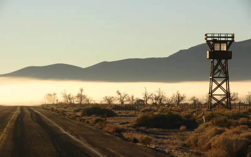guard tower with fog and hills in background