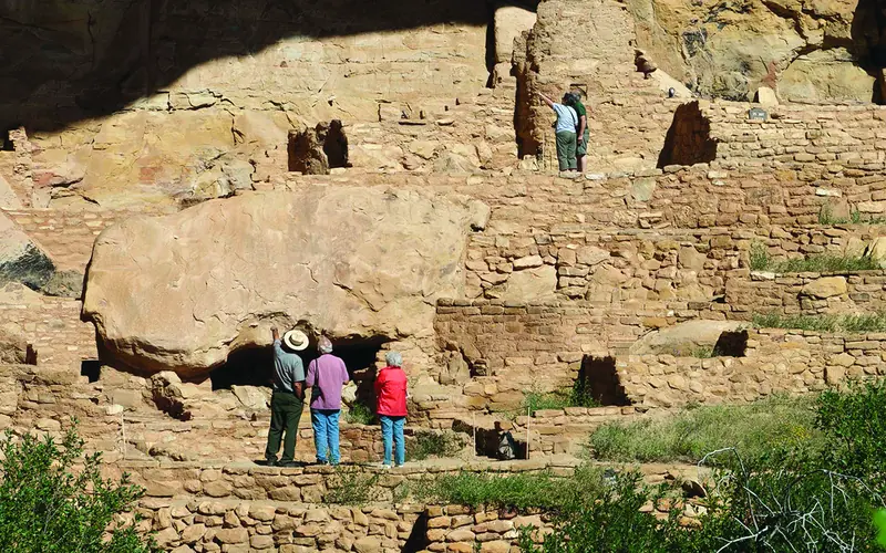 Park visitors visiting a cliff dwelling
