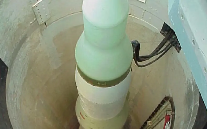 A cylindrical missile inside an underground silo.