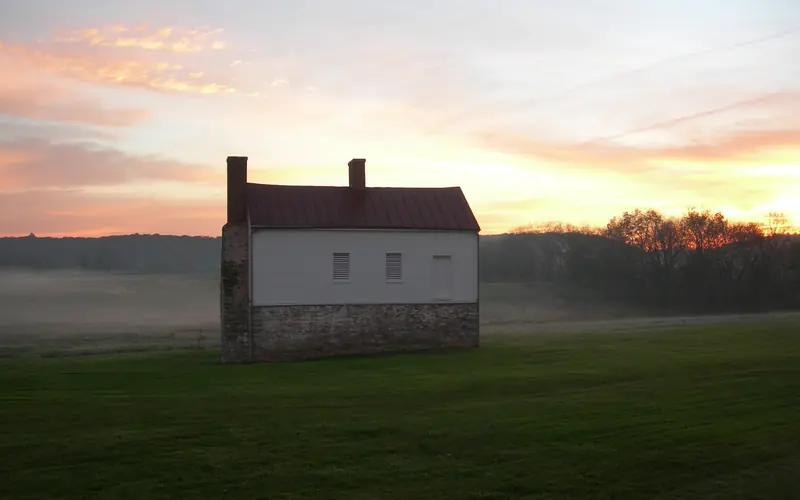 Sun rise and fog behind the historic Secondary House on the Best Farm.