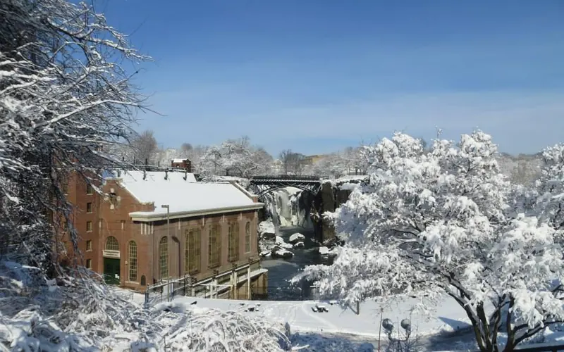 snow covered hydro plant and waterfall