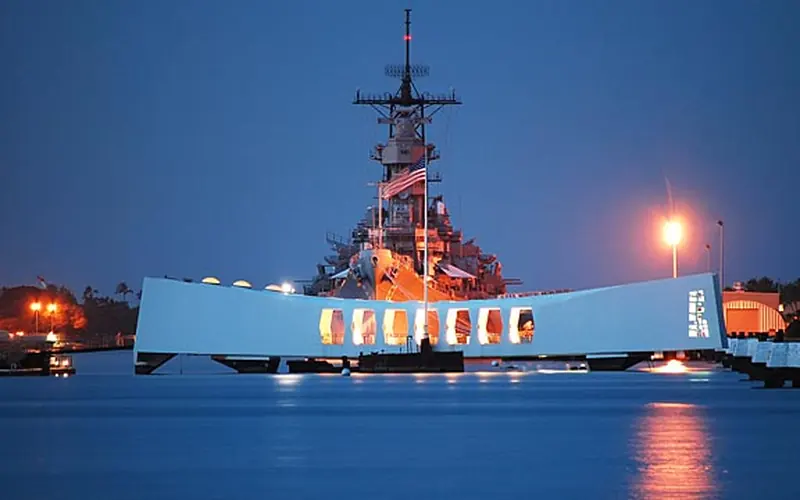The USS Arizona Memorial in front of the USS Missouri.