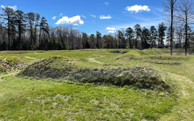Earthworks covered in green grass.