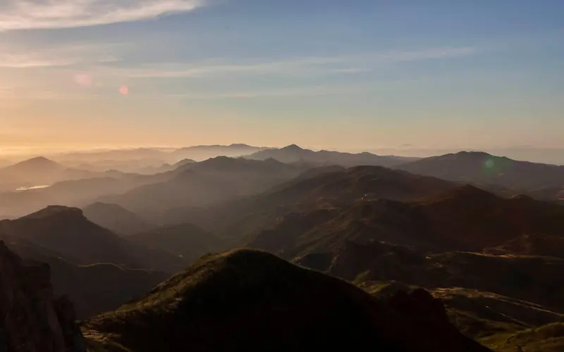Mountain silhouettes at sunrise.