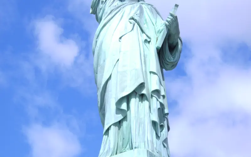 Entire patina green Statue of Liberty and very top of granite pedestal