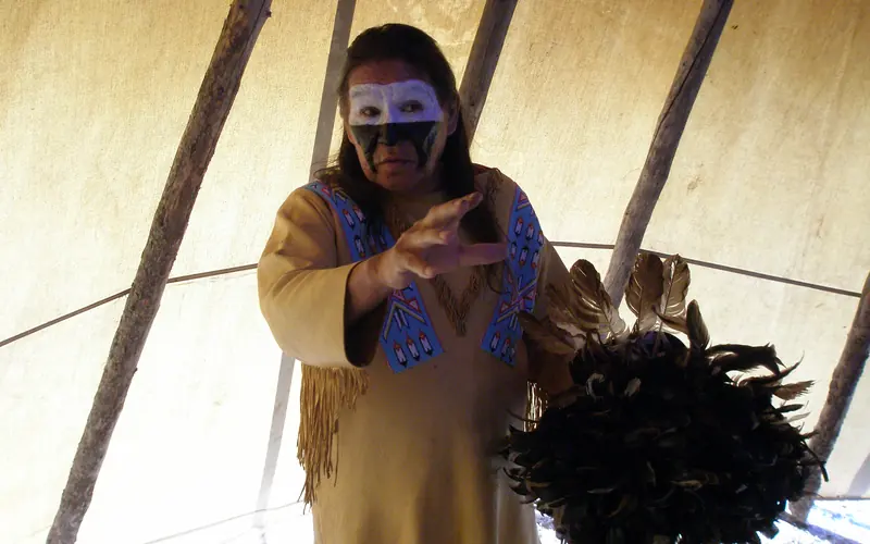 A Cheyenne Dog Soldier tells stories inside his tipi