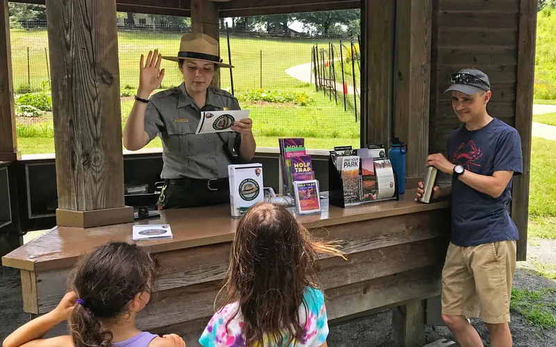 A ranger swears in two new Jr. Rangers during Jr. Ranger Day activities at the park.