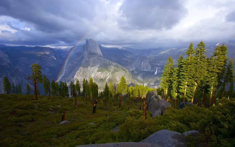 A rainbow over a mountain in the distance.